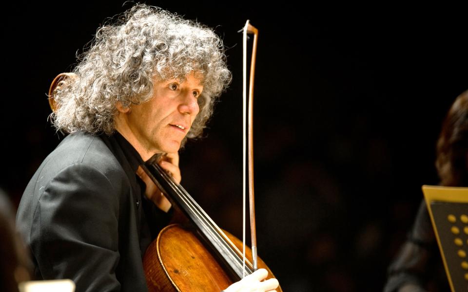 Cellist Steven Isserlis on stage, playing