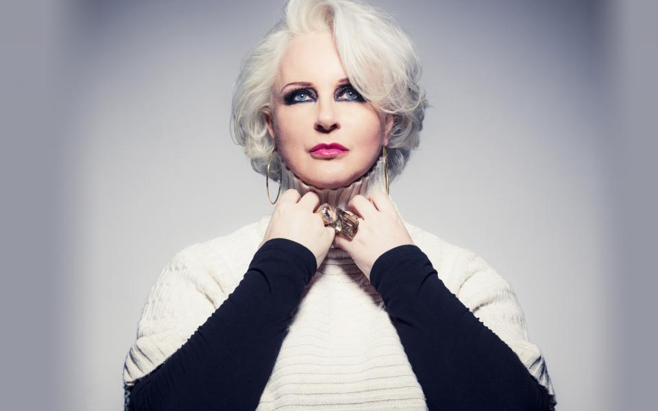 Singer Irene Theorin wearing a white jumper over a black shirt and jewelry