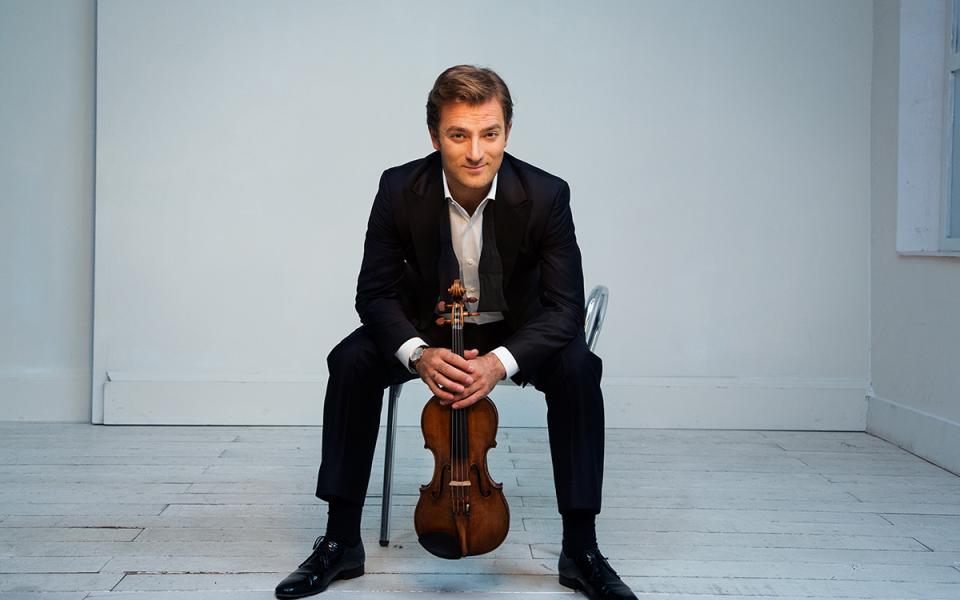 231025 Appalachian Spring Renaud Capucon Credit Simon Fowler Renaud Capucon sitting on a chair holding violin