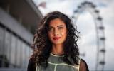 Headshot of Vidya Patel looking into the camera, with the London Eye in the background