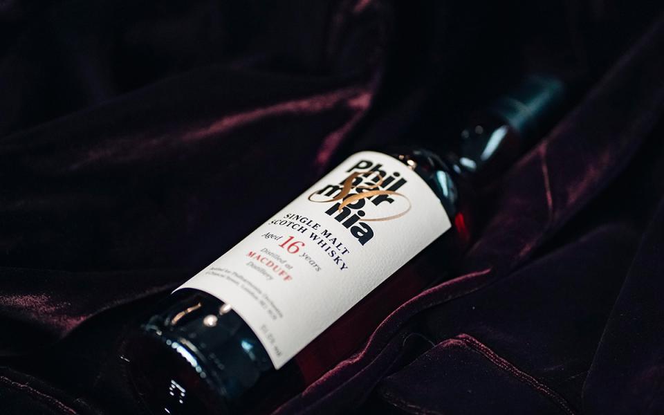 Philharmonia Whisky bottle laid down on a dark purple velvet fabric