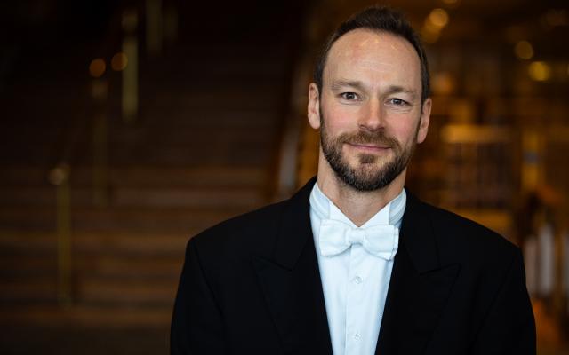 Tom Edwards smiling at camera in Royal Festival Hall