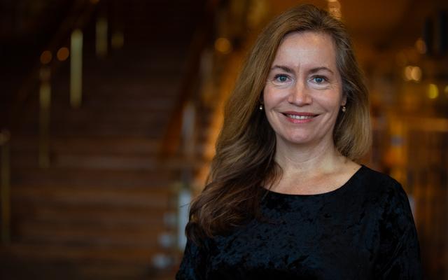 Marina Gillam smiling at camera in front of stairs at the RFH