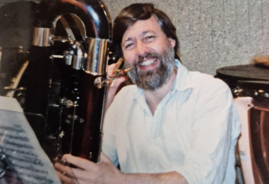 Nick Reader smiling, with a contrabassoon.