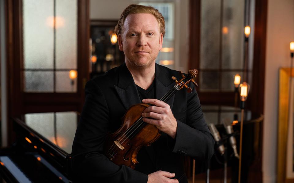 Daniel Hope holding his violin